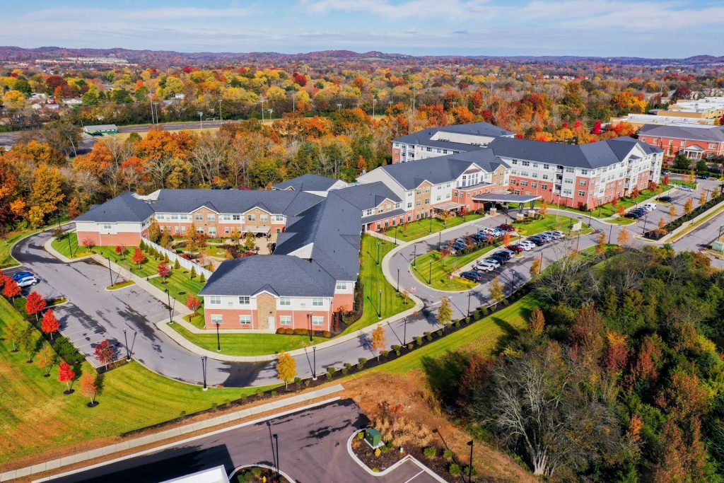 Aerial view of Clarendale at Indian Lake, a senior living community in a scenic autumn landscape.